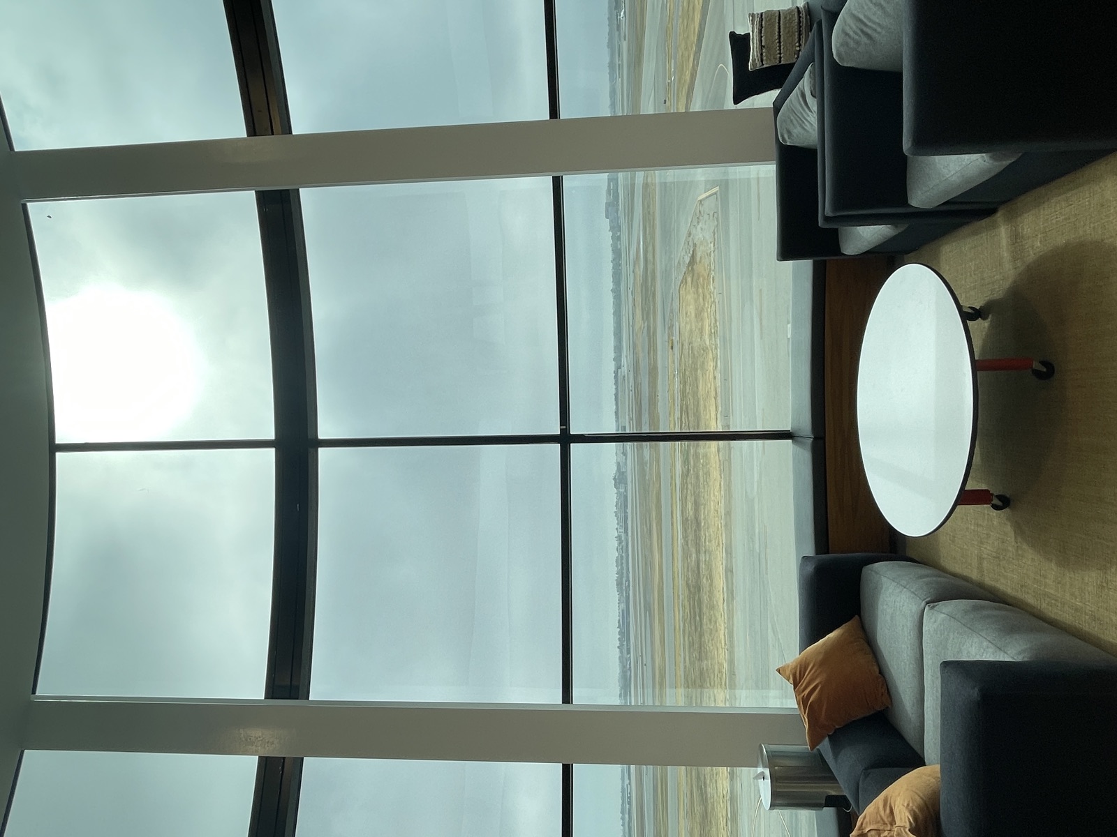 Floor-to-ceiling windows overlooking the Long Beach Airport runways